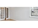 Room featuring hardwood floors, natural light, and double doors at 1400 Colony Dr, Erie, CO 80026