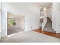 Bright, open living room with neutral carpet, staircase, and lots of natural light at 5479 Lost Meadow Trl, Castle Rock, CO 80104