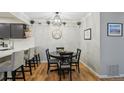 The dining area is adjacent to the kitchen and features an elegant light fixture at 2355 E Geddes Ave # C24, Littleton, CO 80122