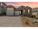 Charming home with a two-car garage, stone accents, and well-maintained landscaping at 3059 Morningbird Ln, Castle Rock, CO 80109