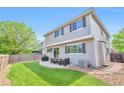 Spacious backyard with a patio, lush lawn, and privacy fence, perfect for outdoor entertaining at 7472 S Memphis St, Aurora, CO 80016