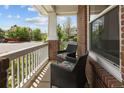 Relaxing front porch featuring comfortable seating with floral patterned pillows and charming neighborhood views at 10109 E 28Th Ave, Denver, CO 80238