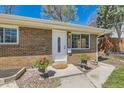 Inviting front entrance with a white door, flower planters, and manicured landscaping at 2217 King St, Denver, CO 80211