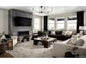 Spacious living room featuring a fireplace, modern lighting, and comfortable seating area at 23738 E 42Nd Ave, Aurora, CO 80019