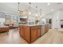 Open concept kitchen features a large island, stainless steel appliances, and a seamless transition to the living area at 9805 Keenan St, Highlands Ranch, CO 80130