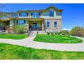Charming two-story home boasts stone accents, a well-maintained lawn, and a welcoming front porch at 5906 S Youngfield Way, Littleton, CO 80127