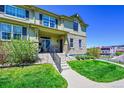 Inviting two-story home boasts stone accents, a well-maintained lawn, and a charming front porch at 5906 S Youngfield Way, Littleton, CO 80127