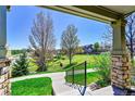 Relaxing view from covered porch of grassy common area and view to the neighborhood at 5906 S Youngfield Way, Littleton, CO 80127