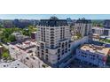 Luxury high-rise building with a pool and surrounding cityscape at 975 N Lincoln St # 15A, Denver, CO 80203