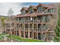 Multi-story condo building showcasing exterior balconies, stone accents, and well-maintained landscaping at 34 Highfield Trl # 311, Breckenridge, CO 80424