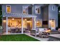 An outdoor oasis, featuring a pergola-covered patio with a fire pit, comfortable seating and dining area at 2130 S Milwaukee St, Denver, CO 80210