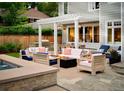 Beautiful patio with outdoor kitchen, cozy seating around a fire pit, and integrated spa at 2130 S Milwaukee St, Denver, CO 80210