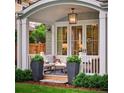 Inviting porch with comfortable seating, stylish lighting, and view of the well-manicured lawn at 2130 S Milwaukee St, Denver, CO 80210