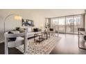 Inviting living room featuring a comfortable sofa, a large rug, and floor to ceiling windows at 955 Eudora St # 407E, Denver, CO 80220