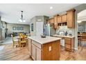 Spacious kitchen with a center island, wooden cabinets, and stainless steel appliances at 1033 Petras St, Erie, CO 80516