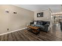 Comfortable living room featuring modern wood floors and access to other living areas at 8909 Field St # 102, Broomfield, CO 80021