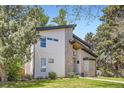 Modern home with a stone facade, clean lines, and manicured landscaping at 1533 S Columbine St, Denver, CO 80210