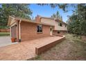 Brick house with an attached garage and a stamped concrete driveway, blending functionality with aesthetic appeal at 30321 Chestnut Dr, Evergreen, CO 80439