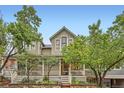 Charming two-story home with a inviting front porch, beautiful stonework and mature trees at 753 Pearl St, Boulder, CO 80302