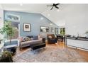 Bright living room with high ceilings, stylish decor, and hardwood floors at 9494 Devonshire Pl, Highlands Ranch, CO 80126