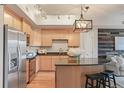 Charming kitchen with granite counters, an island with bar seating, and stainless steel appliances at 640 11Th St # 302, Golden, CO 80401
