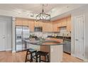 Bright kitchen featuring granite countertops, stainless steel appliances, a kitchen island, and light cabinetry at 640 11Th St # 302, Golden, CO 80401