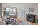 Sunlit living room with a fireplace, a decorative rug, and a large window offering great views at 640 11Th St # 302, Golden, CO 80401