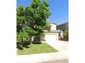Charming two-story home with a well-maintained front yard and a two-car garage at 5483 Ben Park Cir, Parker, CO 80134