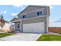 Charming home with a two-car garage, gray siding, and a well-kept lawn at 7220 Big Thompson Ct, Frederick, CO 80530
