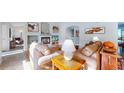 Spacious living room with a fireplace, hardwood floors, and bright natural light at 6260 Rain Dance Trl, Littleton, CO 80125