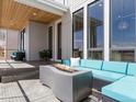 Relaxing outdoor patio featuring a modern fire pit and comfortable seating area at 5835 Chester Way, Denver, CO 80238