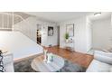 Spacious living room featuring wood floors, staircase, and stylish accents at 12648 W Virginia Ave, Lakewood, CO 80228