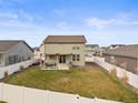 Large backyard featuring a well-maintained lawn, privacy fence, and a cozy patio area, perfect for outdoor enjoyment at 1527 Biffle Ct, Berthoud, CO 80513