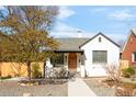 Charming home featuring a well-maintained yard, arched doorway, and freshly painted exterior at 945 Jackson St, Denver, CO 80206