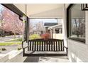 Relaxing front porch with swing and view of the neighborhood at 945 Jackson St, Denver, CO 80206