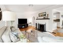 Cozy living room featuring a fireplace, hardwood floors, and stylish furnishings at 945 Jackson St, Denver, CO 80206