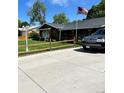 This home features a well-manicured lawn, a covered porch, and a spacious driveway at 840 Essex Dr, Denver, CO 80229