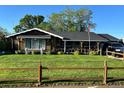 A well-maintained front lawn is complemented by charming landscaping and a covered front porch at 840 Essex Dr, Denver, CO 80229