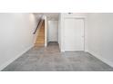 Open entryway featuring tile floors, a staircase, and convenient closet space, perfect for a welcoming foyer at 3520 W Conejos Pl # 11, Denver, CO 80204