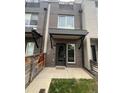 Charming brick townhouse featuring an inviting entrance with modern awning and well-maintained landscaping at 3520 W Conejos Pl # 11, Denver, CO 80204