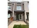 Charming townhome featuring brick facade and covered entryway, offering a welcoming curb appeal at 3520 W Conejos Pl # 11, Denver, CO 80204