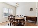 Dining room features hardwood floors, a modern light fixture, and a window at 9533 Cherry Ln, Thornton, CO 80229