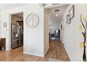 Hallway with hardwood floors leading to kitchen and living room at 9533 Cherry Ln, Thornton, CO 80229