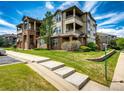 View of the exterior of the condo complex showing well-maintained lawns and garden areas at 12820 Ironstone Way # 103, Parker, CO 80134
