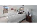 Bright bedroom featuring a comfortable bed, stylish decor, and natural light from a large window at 2 Adams St # 806, Denver, CO 80206