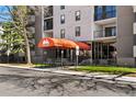 Building entrance featuring an orange awning with the address, street view and bench seating at 2 Adams St # 806, Denver, CO 80206