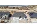 Stunning aerial view of the home, showcasing its prime location near a field and a mountain range at 1581 Diamond Hill Ct, Castle Rock, CO 80104