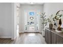 Bright foyer features beautiful hard wood floors, a decorative wreath, and access to the main living areas at 1581 Diamond Hill Ct, Castle Rock, CO 80104