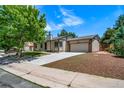 Spacious home featuring a two-car garage and a well-maintained front yard at 4064 S Olathe Ct, Aurora, CO 80013