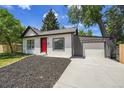 Charming single-story home with a red front door, black mulch, and an attached one car garage at 8801 E 16 Ave, Denver, CO 80220